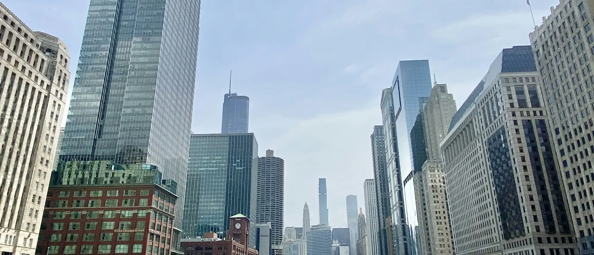 Chicago Riverwalk daytime canyon with downtown high-rises along the river